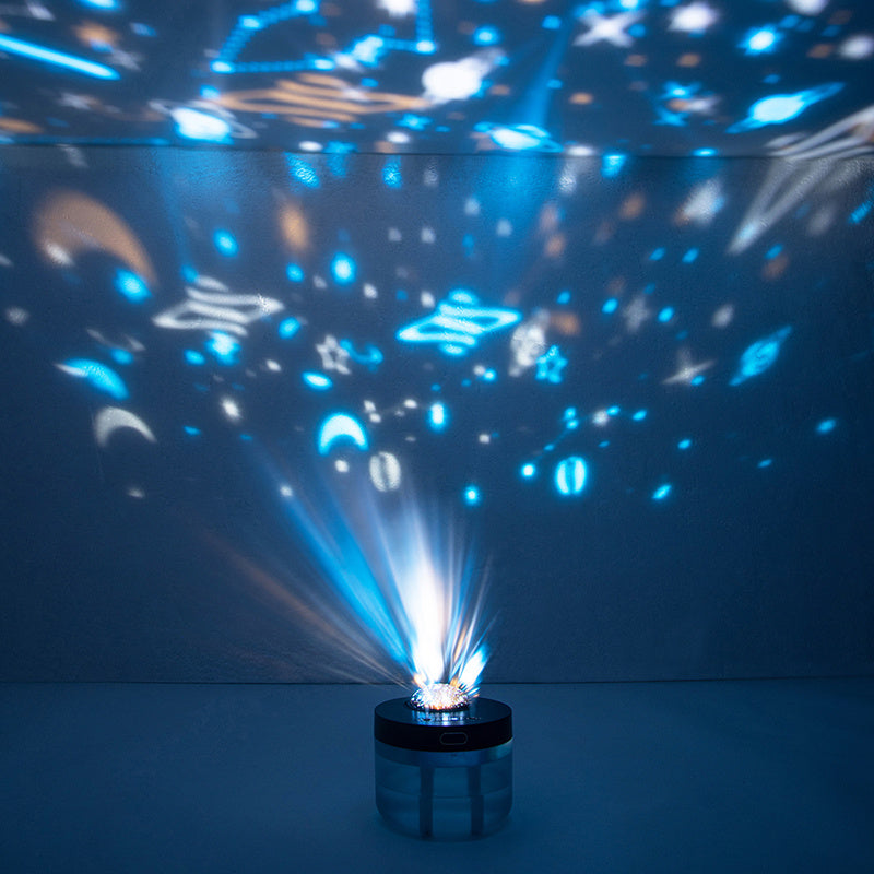 Projection humidifier creating a rotating night sky effect in a dark room