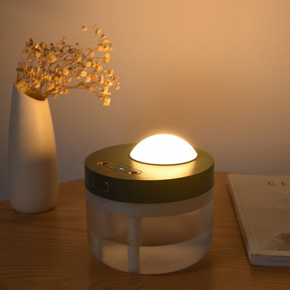 Mist humidifier placed beside a laptop creating a calming workspace atmosphere
