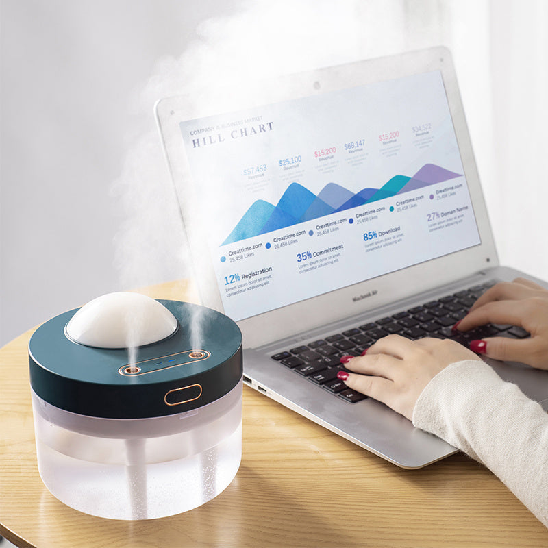 Portable dual-spray humidifier releasing mist on a home desk setup